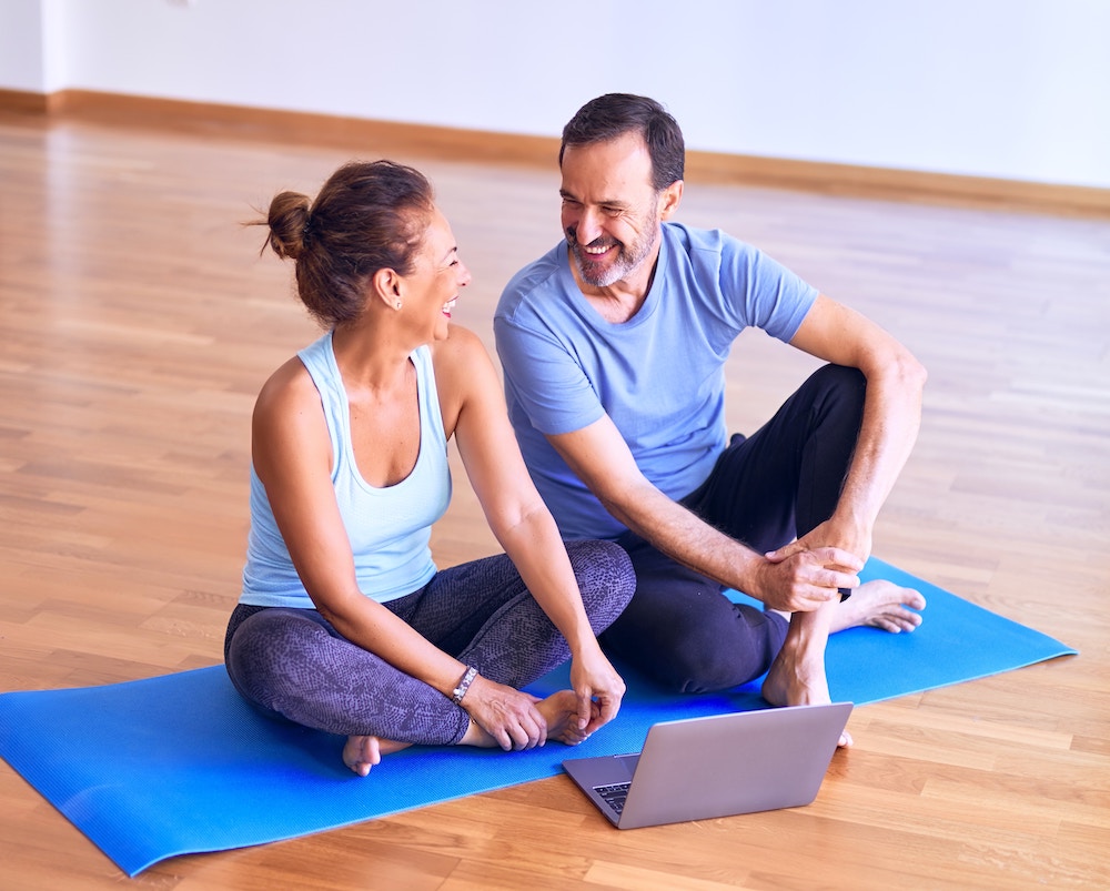 A couple sitting together before a yoga class