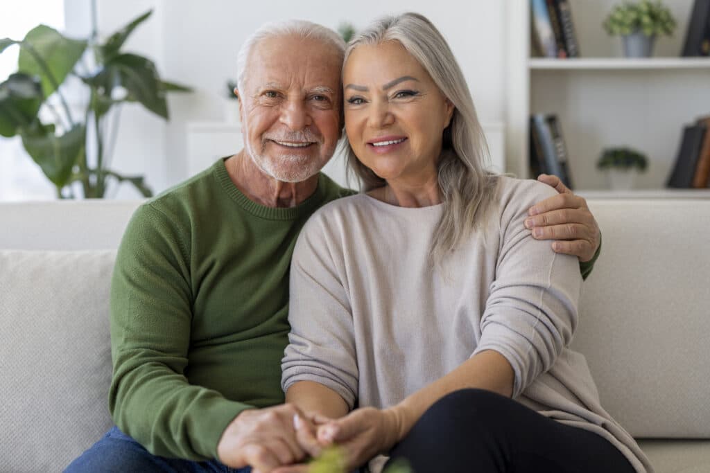 Mature couple hugs on the couch, excited to reintroduce intimacy to their live. Mature couple hugs on the couch, excited to reintroduce intimacy to their live.